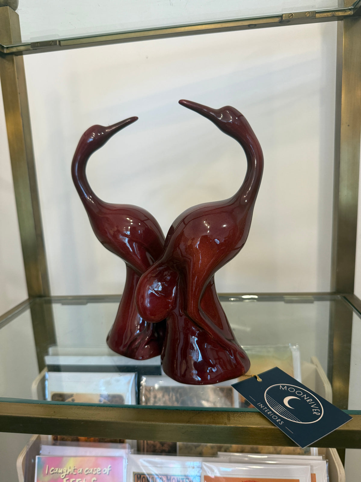 Pair of oxblood glazed ceramic crane figurines, front view