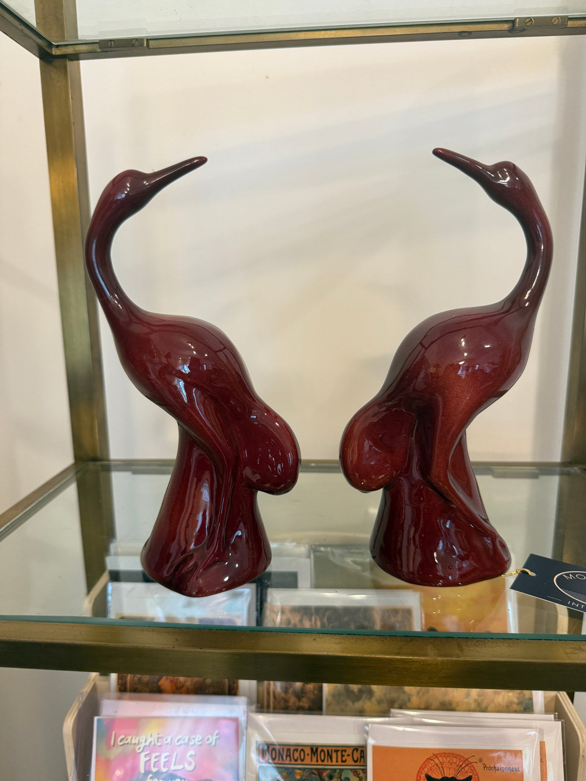 Pair of oxblood glazed ceramic crane figurines, side view
