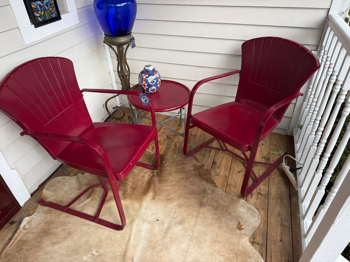 Maroon shell-back steel spring chairs and side table set, front view