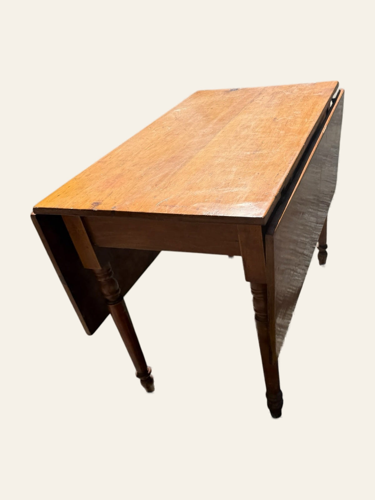 Antique drop-leaf farm table with turned legs, leaves extended