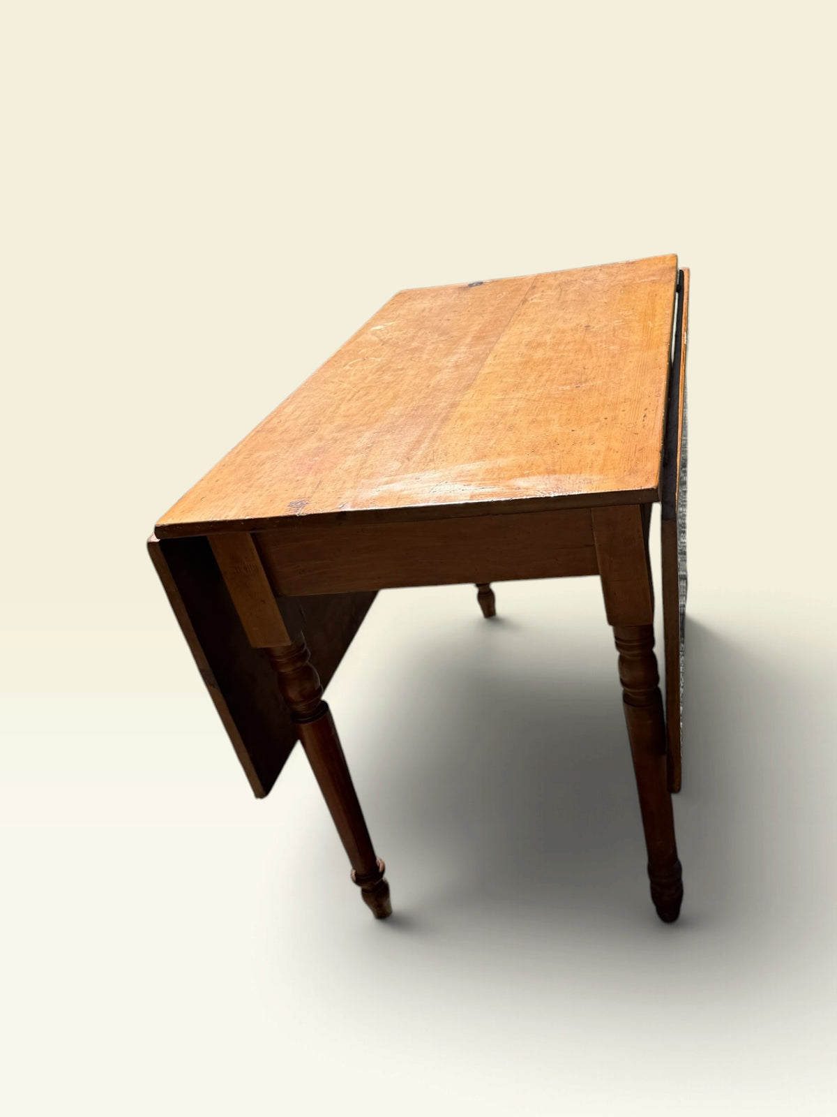 Antique drop-leaf farm table, side view