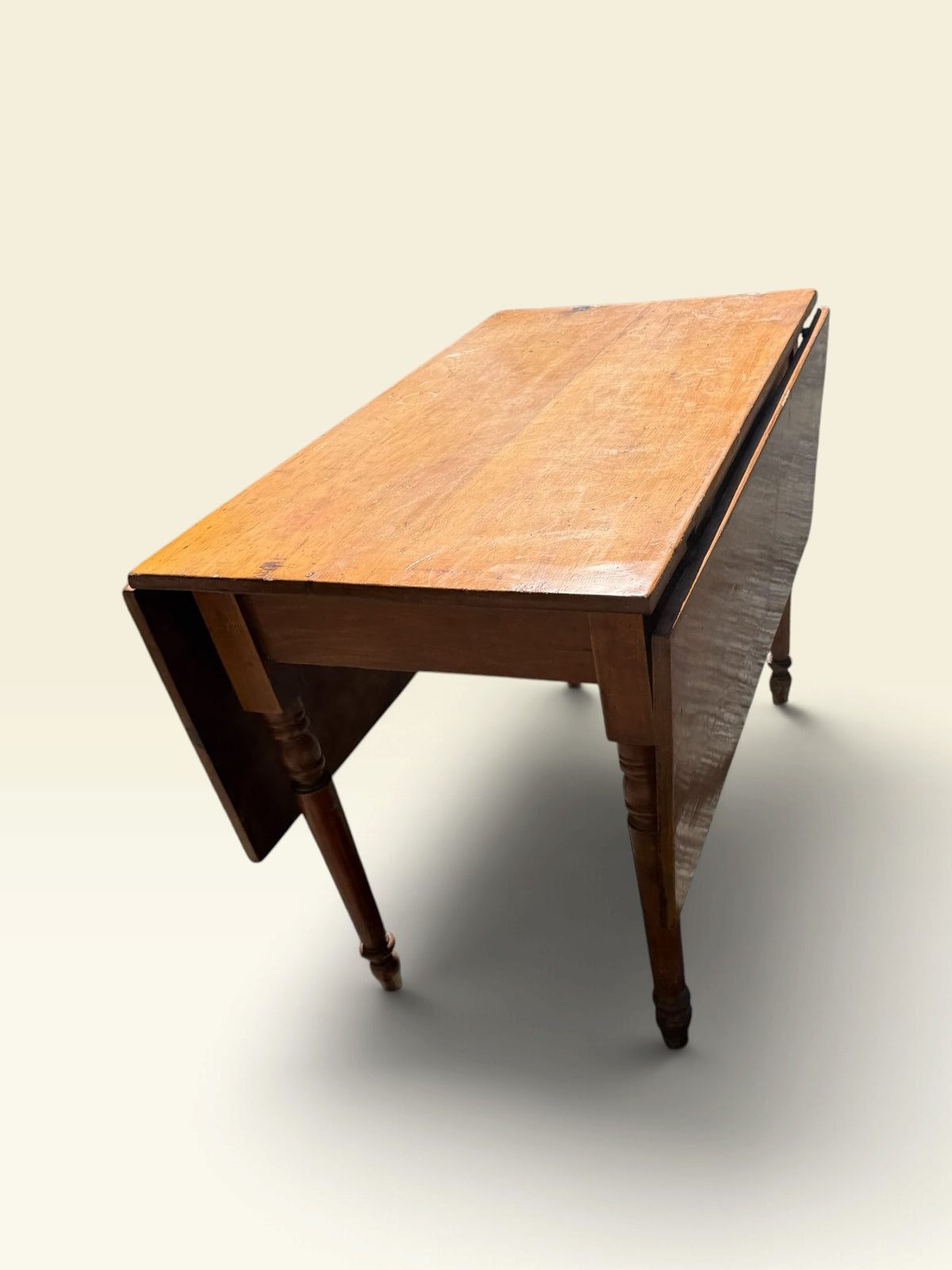 Antique drop-leaf farm table, end view