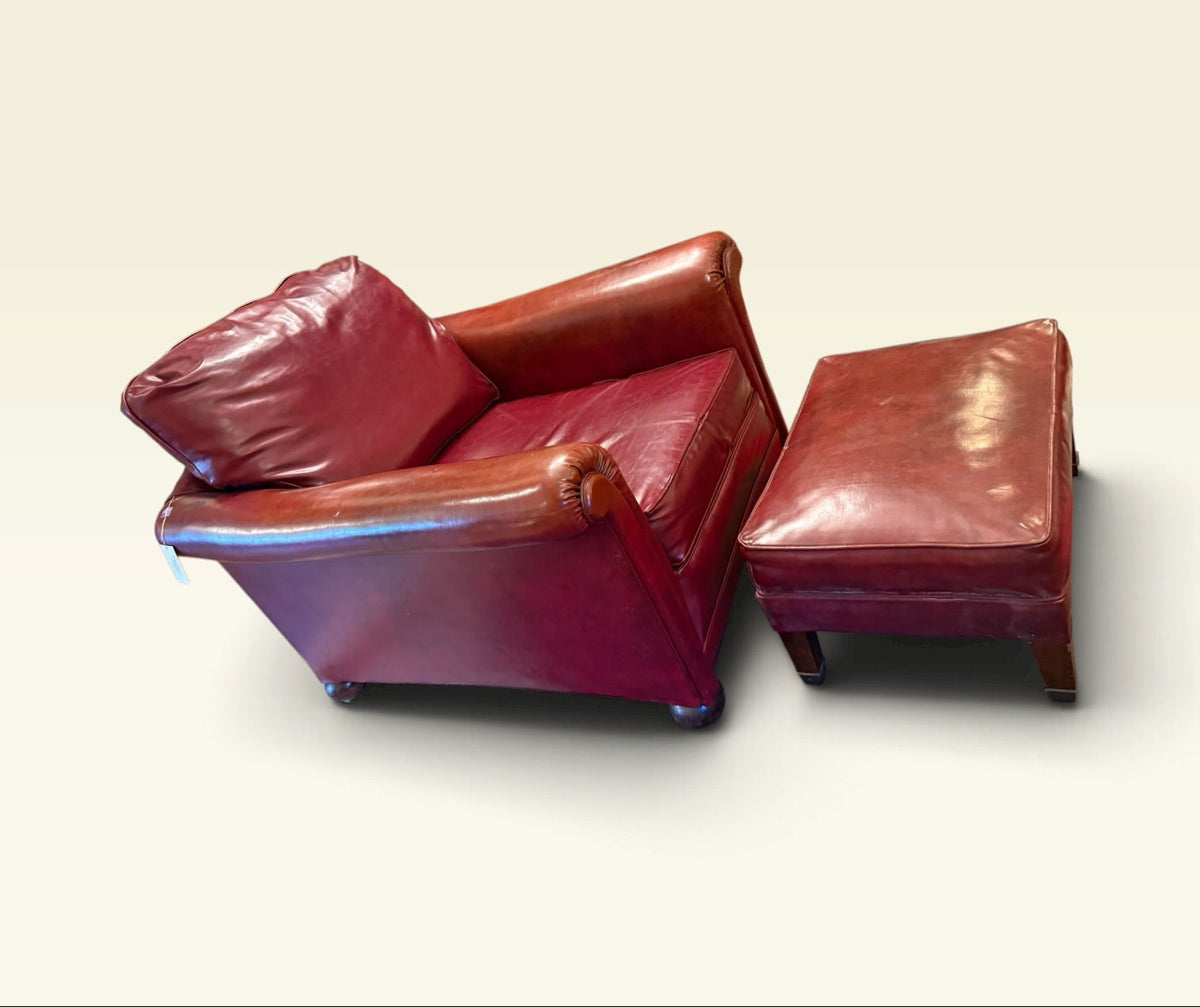Oxblood vinyl club chair and ottoman, side view